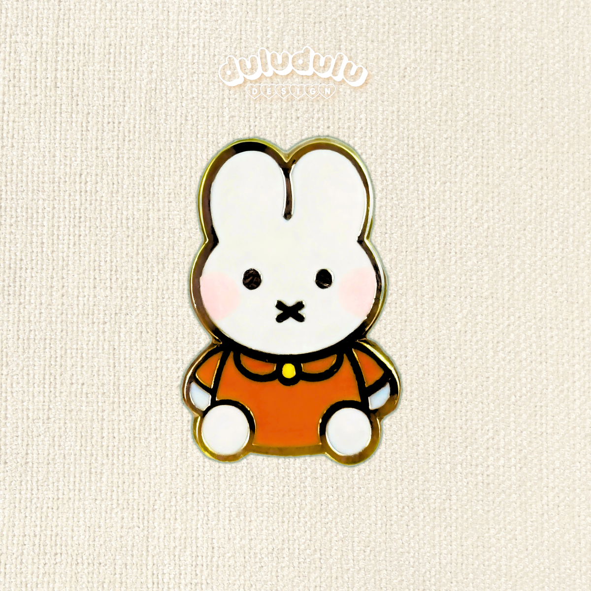 mini orange miffy pin on a plain background