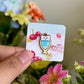 Hand holding bear parfait mini pin under natural lighting