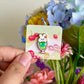 Hand holding bunny parfait mini pin under natural lighting