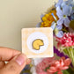 Hand holding fortune cookie mini enamel pin