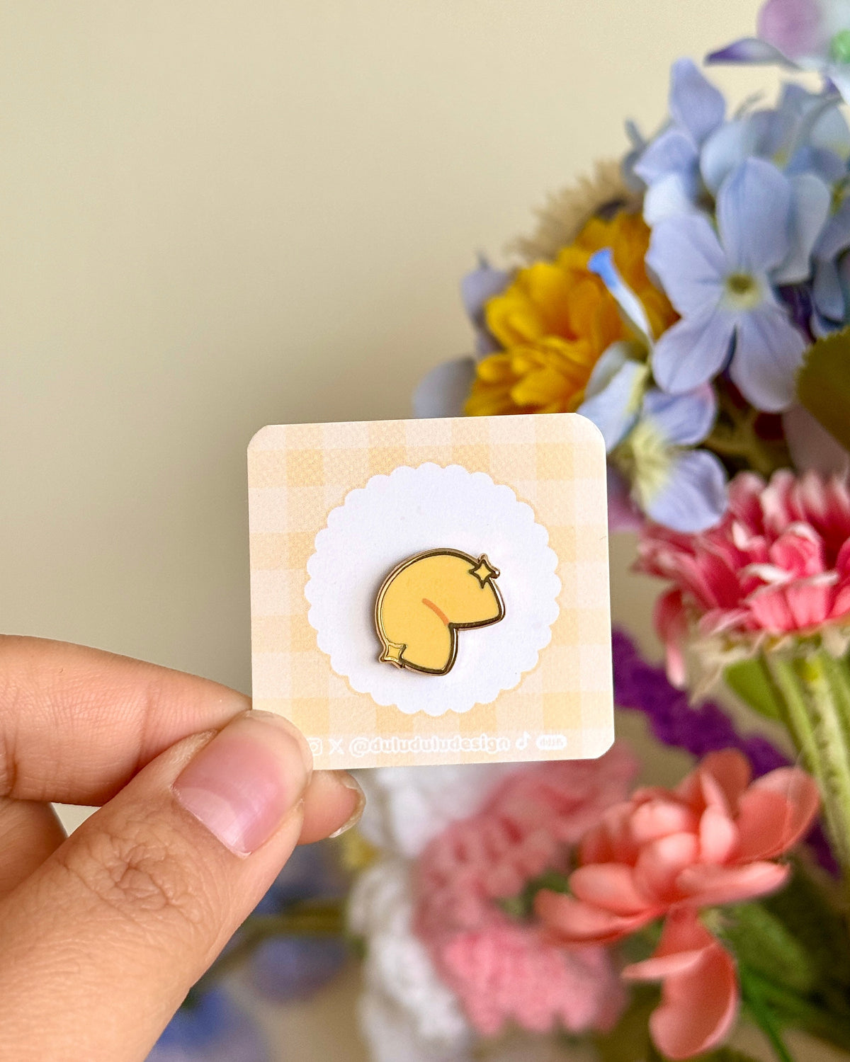 Hand holding fortune cookie mini enamel pin