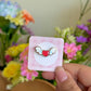Hand holding shoujo heart mini pin