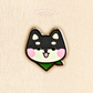 black shiba inu mini pin on a plain background 