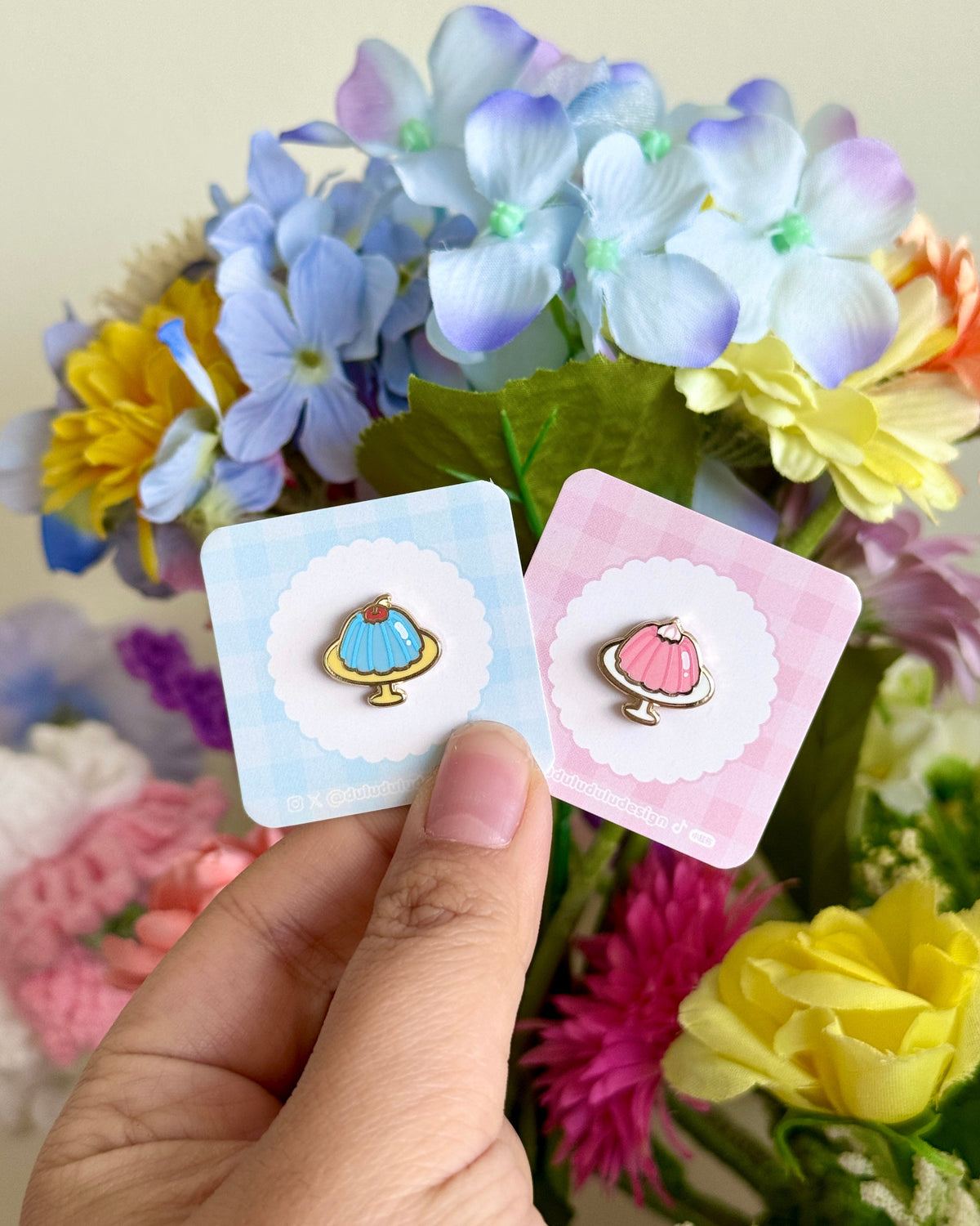 Hand holding blue and pink jello mini pins