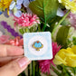 hand holding blue jello mini pin