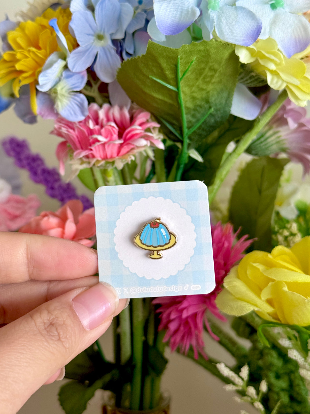 hand holding blue jello mini pin