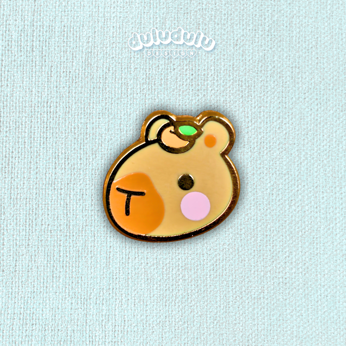capybara mini pin on a plain blue background
