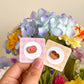 hand holding chocolate and strawberry pretzel mini pins