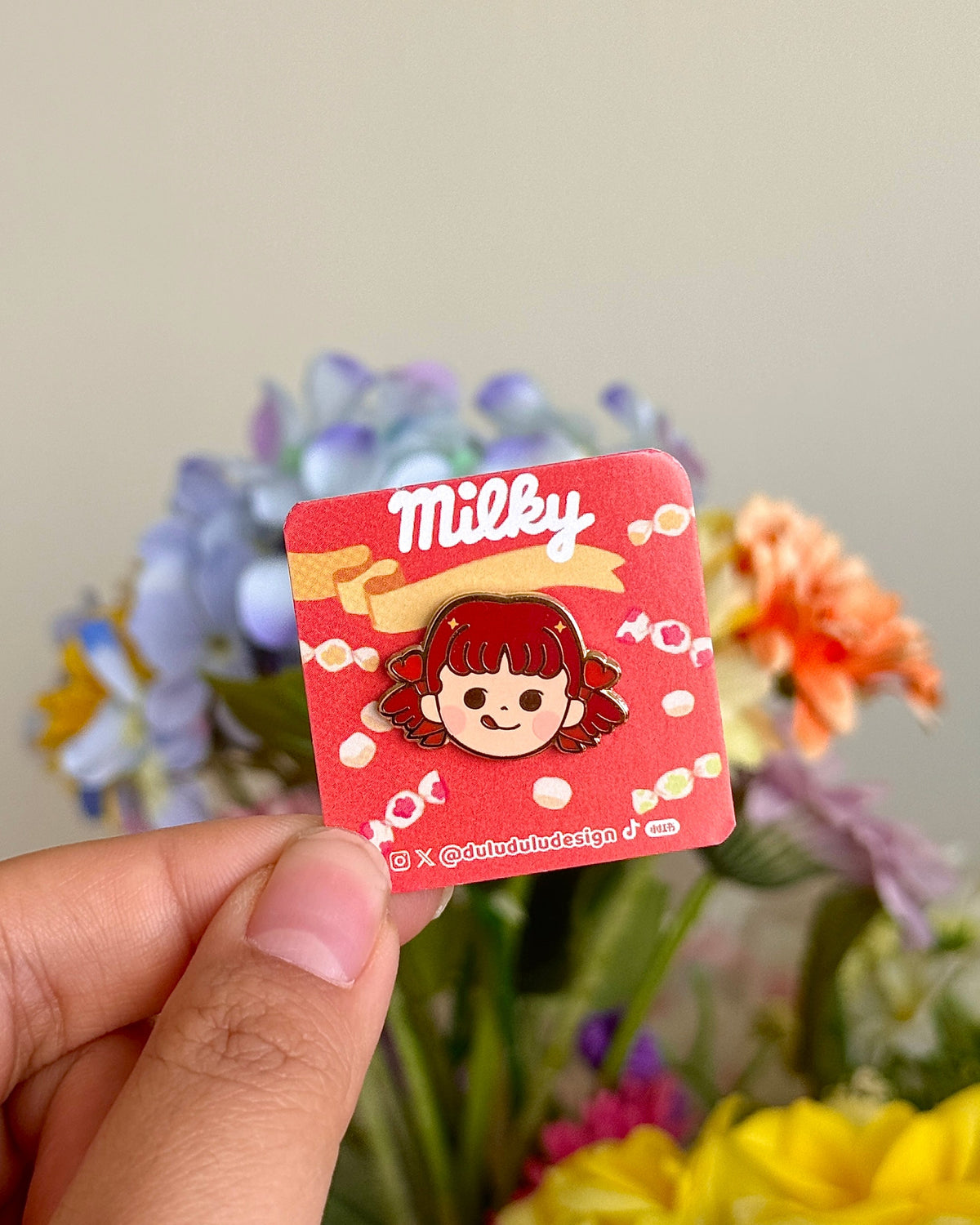 hand holding peko mini pin under natural sunlight