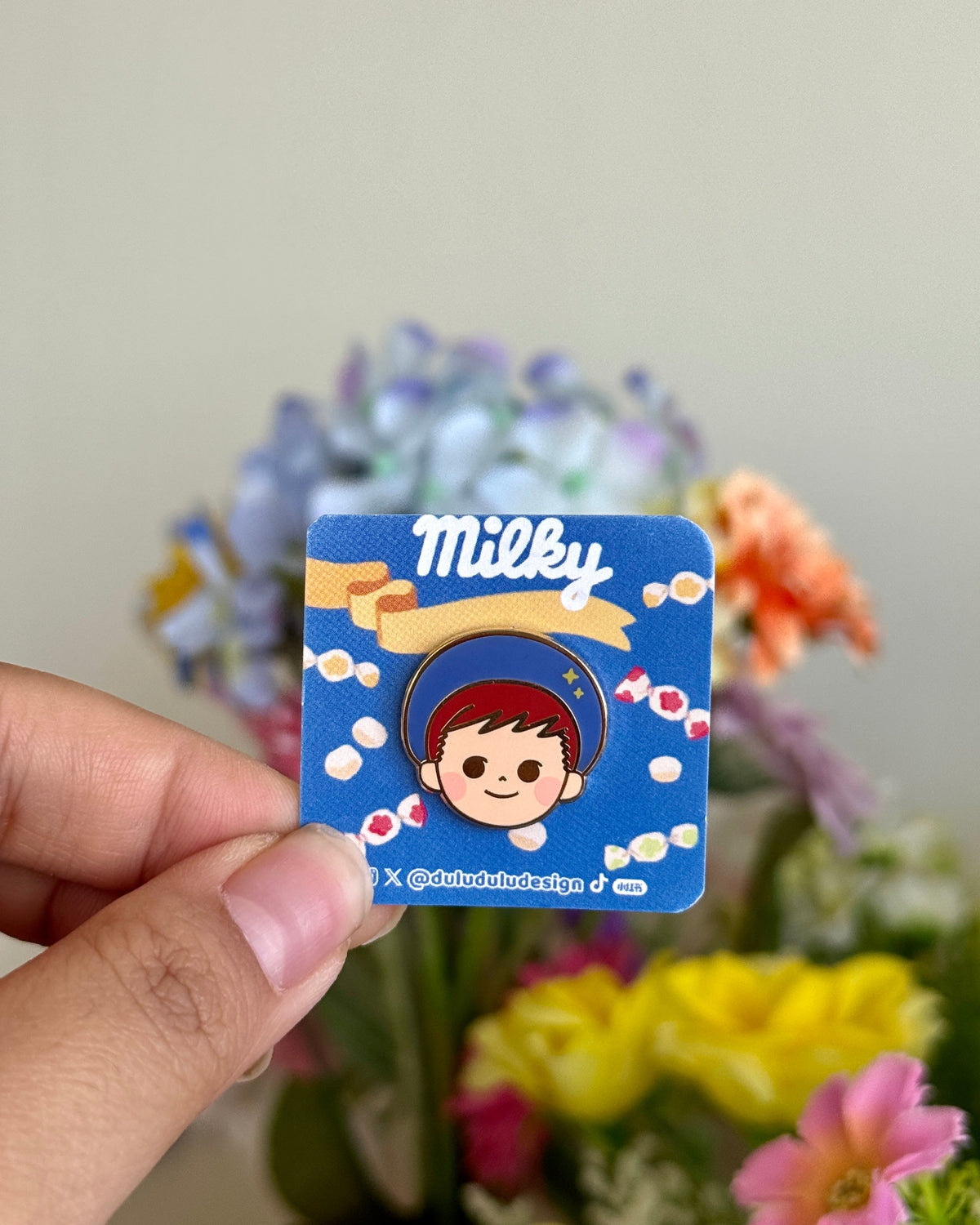 Hand holding poko mini pin under natural sunlight