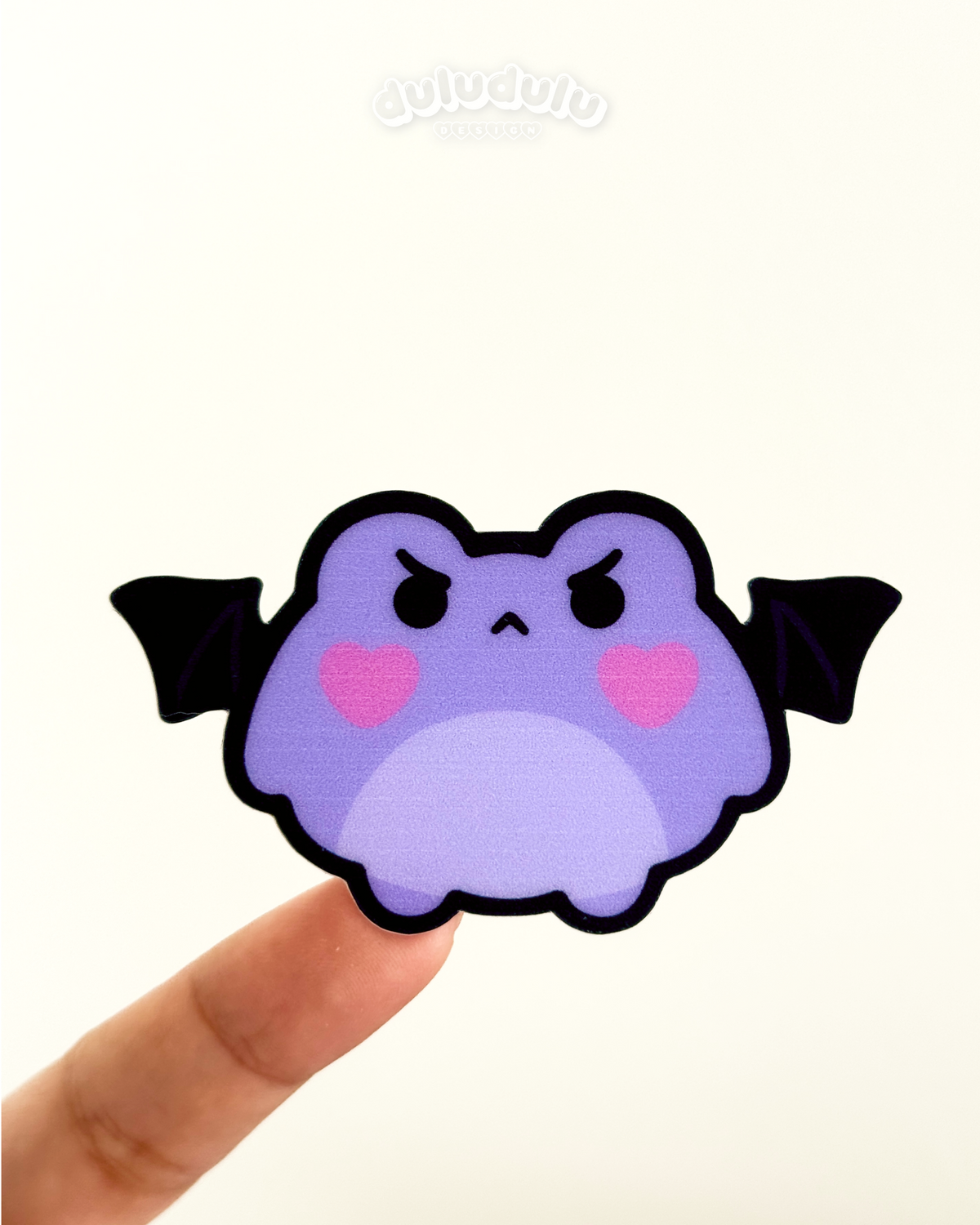 gothic frog pouting with bat wings as a vinyl sticker