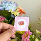 hand holding a strawberry pretzel mini pin
