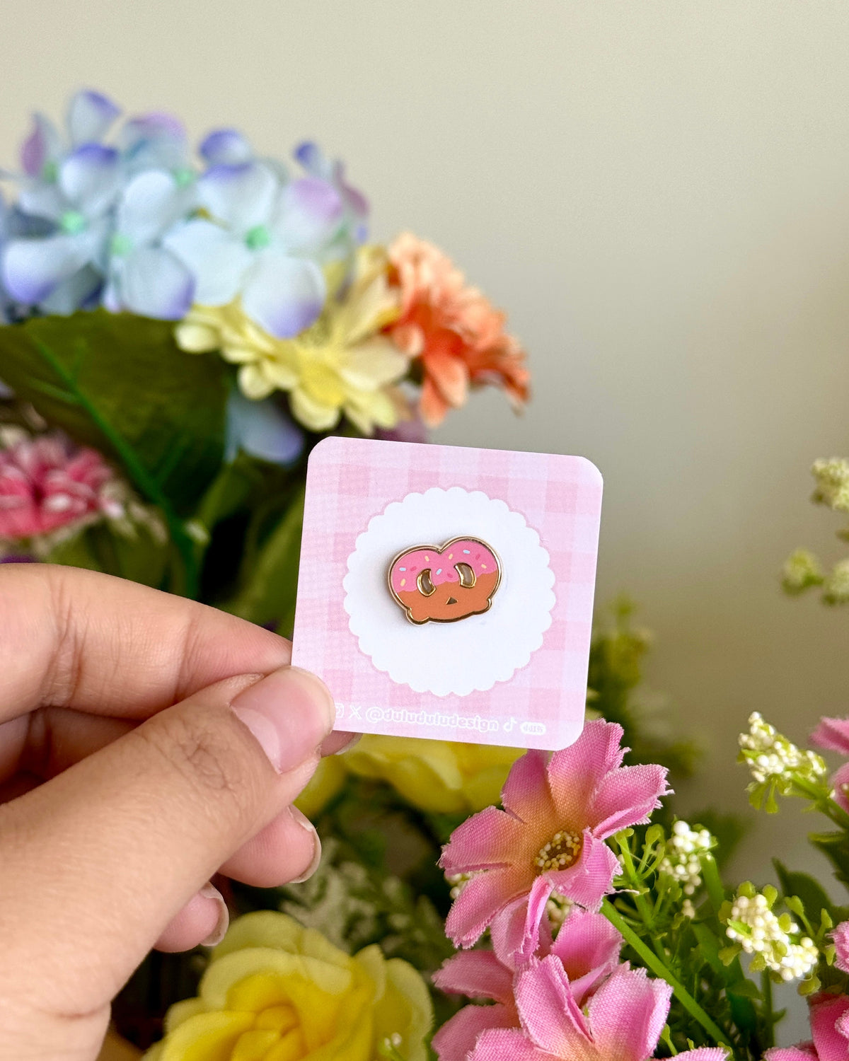 hand holding a strawberry pretzel mini pin